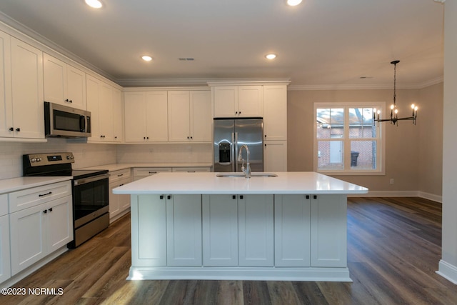 kitchen with ornamental molding, appliances with stainless steel finishes, and dark wood-type flooring