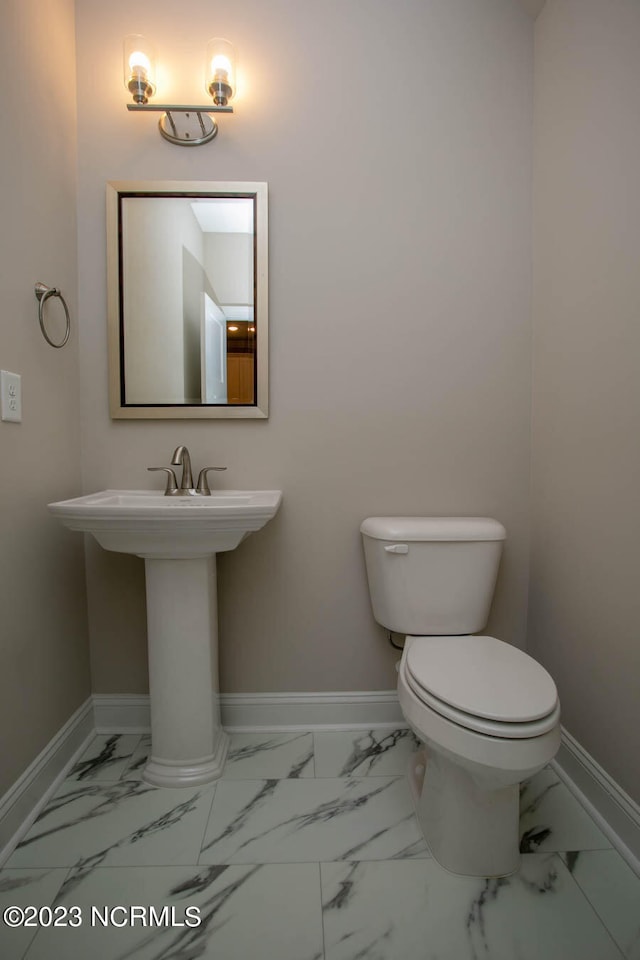 bathroom featuring toilet and tile flooring