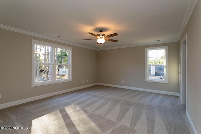 carpeted spare room with ornamental molding and ceiling fan