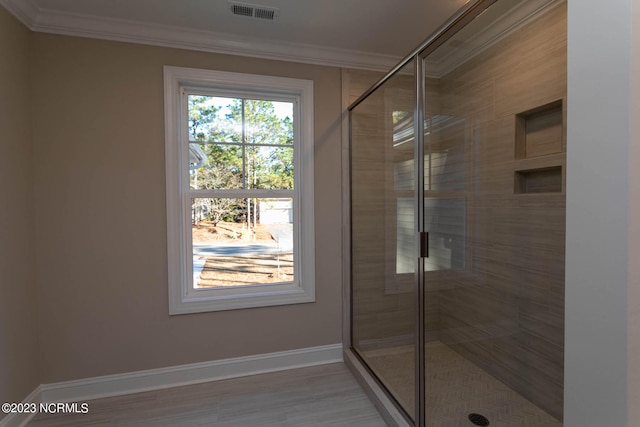 bathroom with ornamental molding and walk in shower