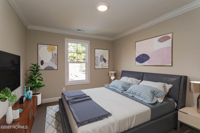 carpeted bedroom featuring crown molding