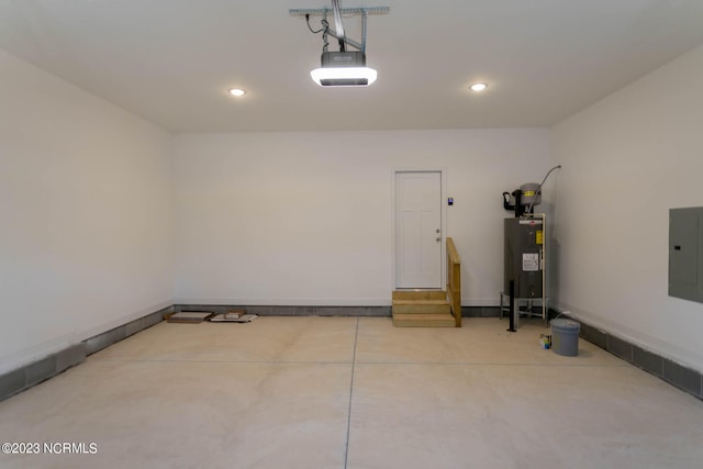 garage featuring a garage door opener and electric water heater