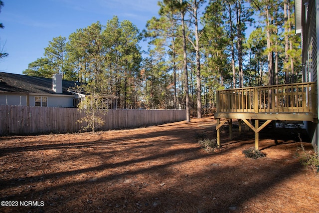 view of yard featuring a wooden deck