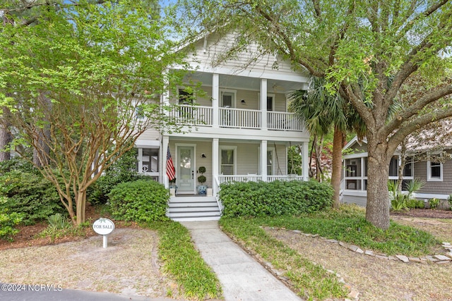 view of front of property featuring covered porch and a balcony