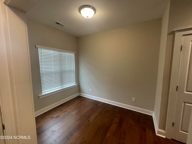 empty room with dark hardwood / wood-style floors