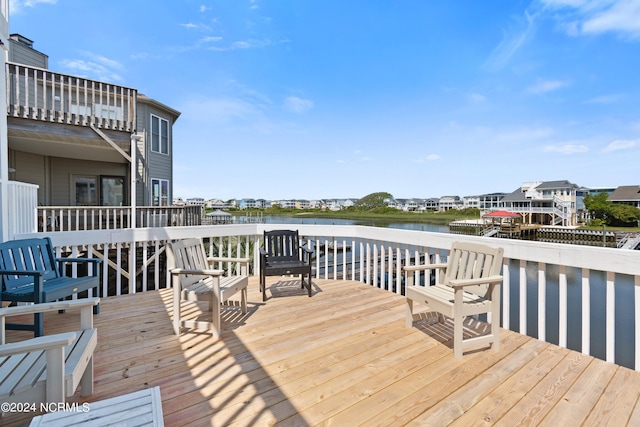 wooden terrace featuring a water view