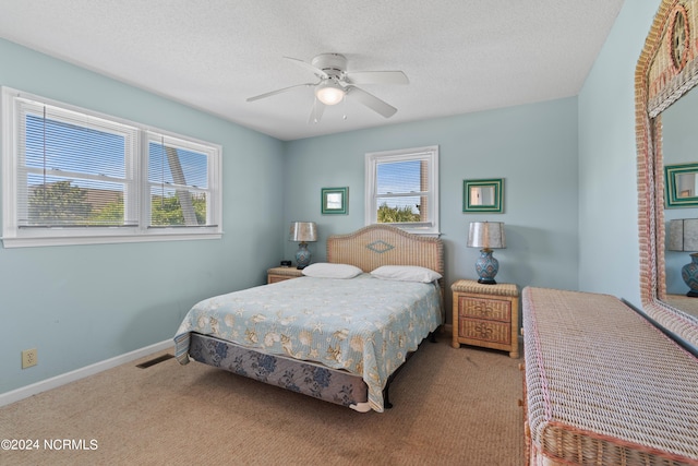 bedroom with carpet flooring, ceiling fan, and multiple windows