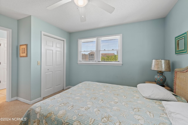 carpeted bedroom with a closet and ceiling fan