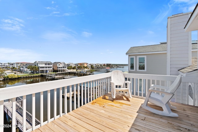 wooden terrace featuring a water view