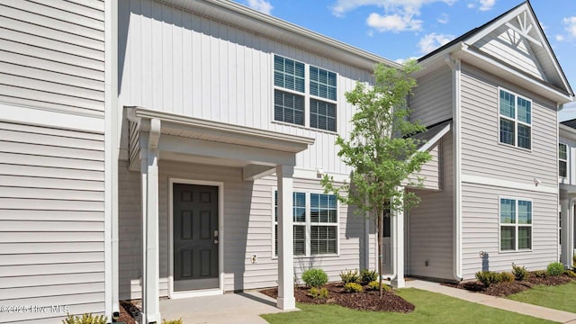 view of front of property with board and batten siding and a front lawn