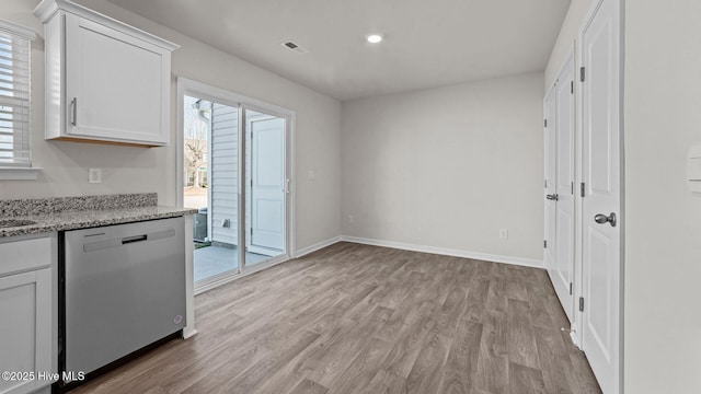 kitchen featuring baseboards, dishwasher, white cabinets, and light wood finished floors