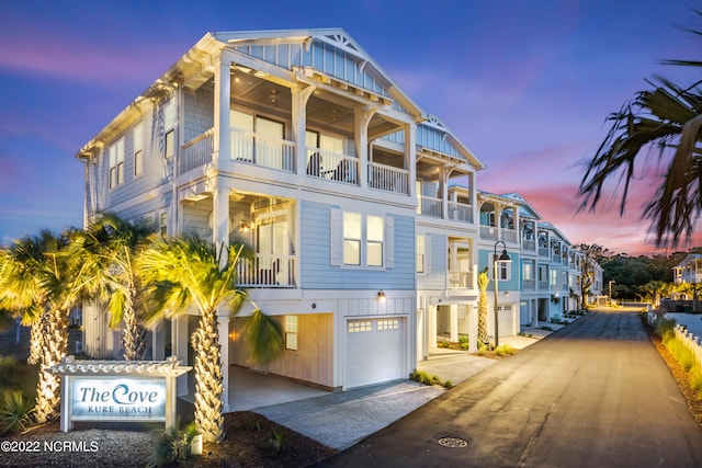 coastal home featuring a garage and a balcony