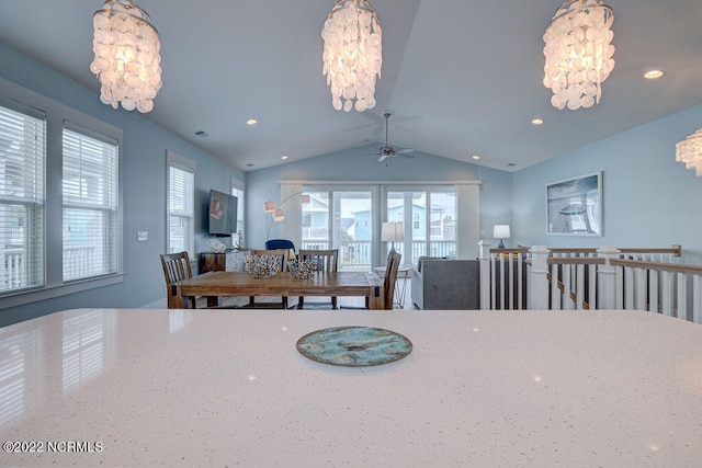 dining room with a notable chandelier and lofted ceiling