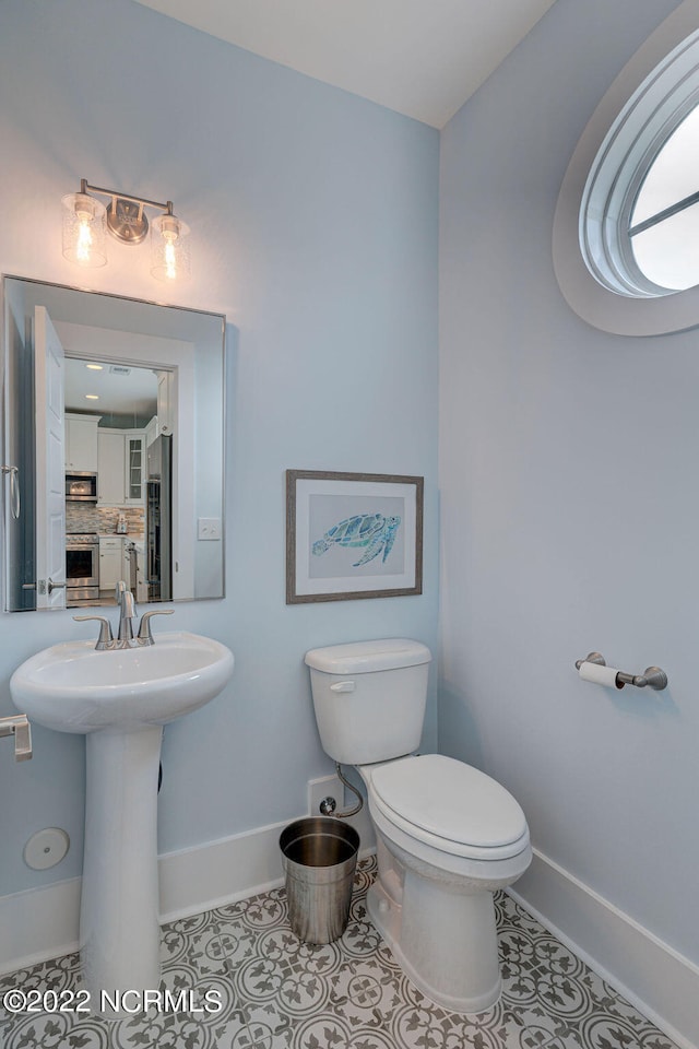 bathroom with tile floors and toilet