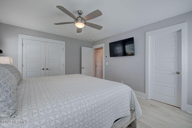 bedroom with a closet, ceiling fan, and light wood-type flooring