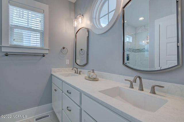 bathroom with dual sinks, tile floors, and large vanity