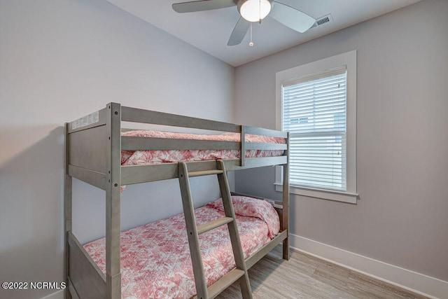 bedroom with light hardwood / wood-style floors and ceiling fan