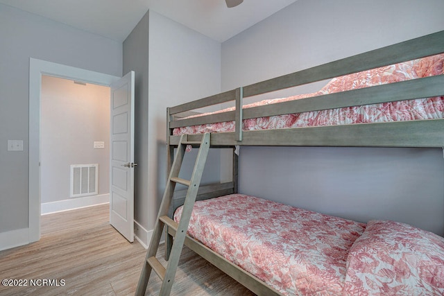 bedroom with light hardwood / wood-style floors and ceiling fan