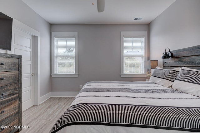 bedroom featuring light hardwood / wood-style floors and ceiling fan