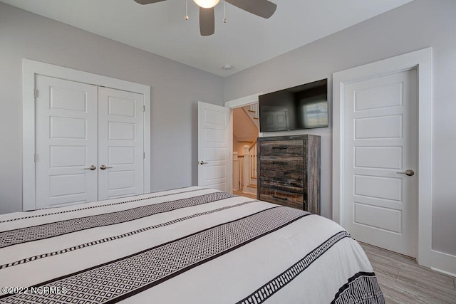 bedroom with a closet, ceiling fan, and light hardwood / wood-style floors