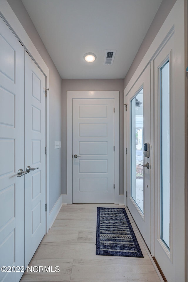 entryway with light hardwood / wood-style floors