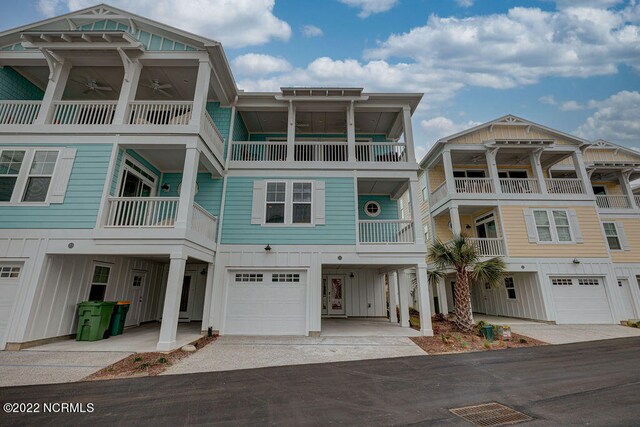 raised beach house with a garage and a balcony