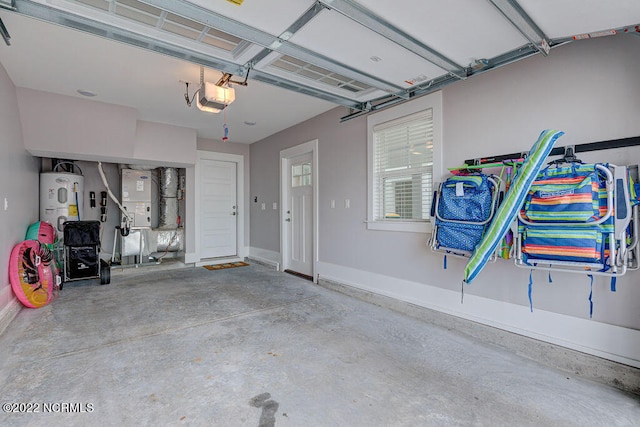 garage featuring a garage door opener, heating utilities, and electric water heater