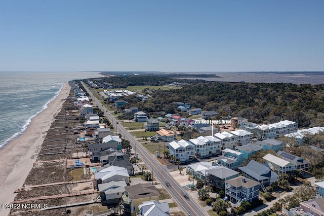 birds eye view of property with a water view and a view of the beach