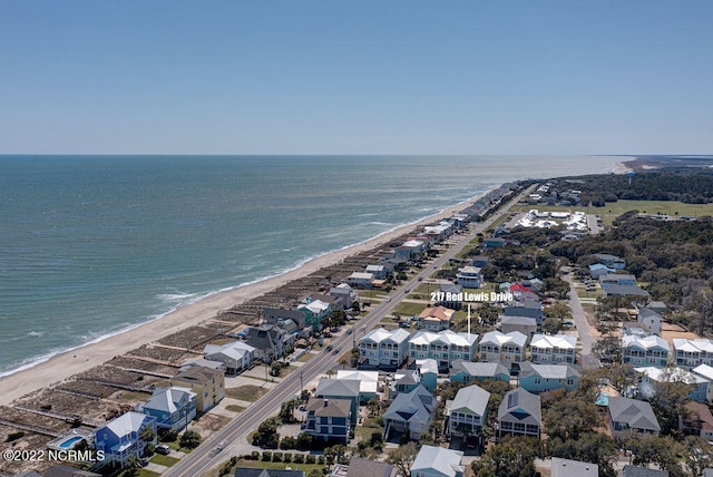 drone / aerial view featuring a beach view and a water view