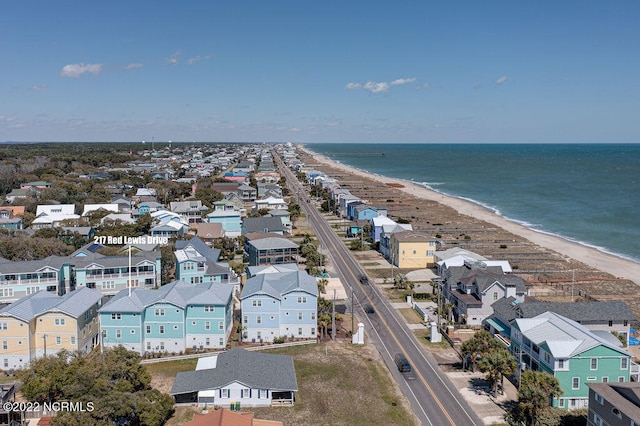 drone / aerial view featuring a water view and a view of the beach