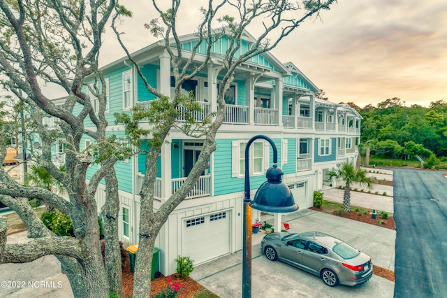 view of front of house featuring a balcony and a garage