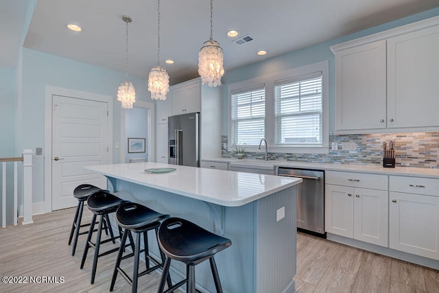 kitchen featuring a center island, white cabinetry, and stainless steel appliances