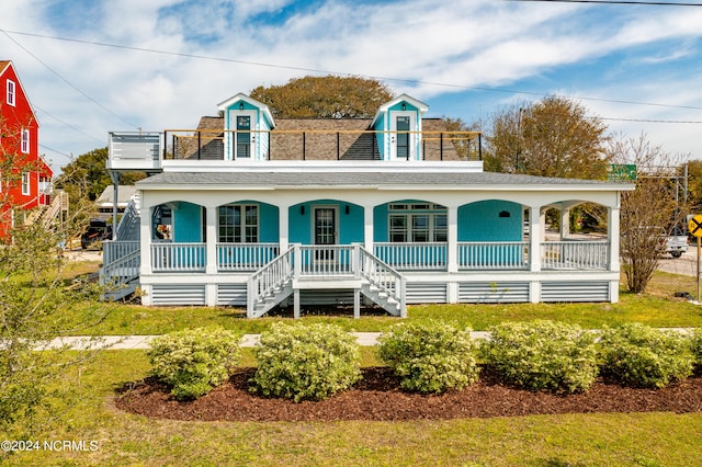 view of front of home featuring a front yard and a porch