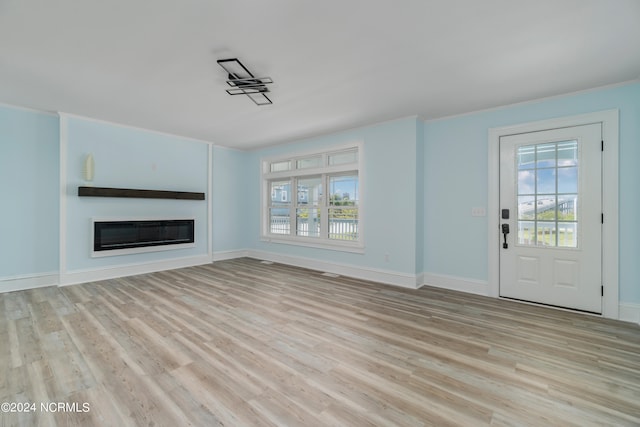 unfurnished living room with a wealth of natural light and light wood-type flooring