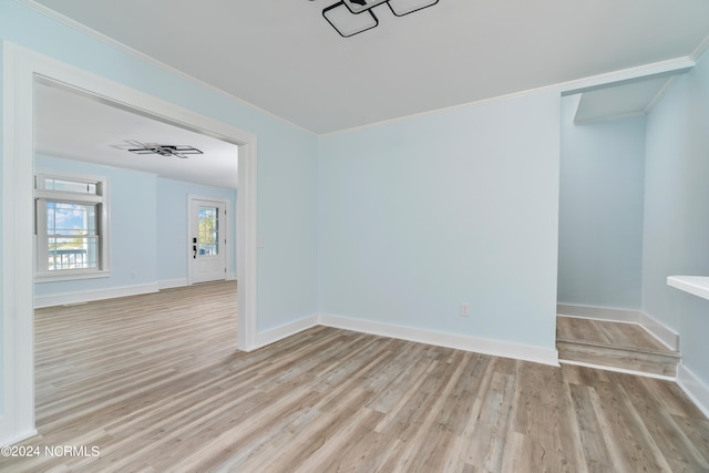 empty room featuring light hardwood / wood-style flooring and ornamental molding