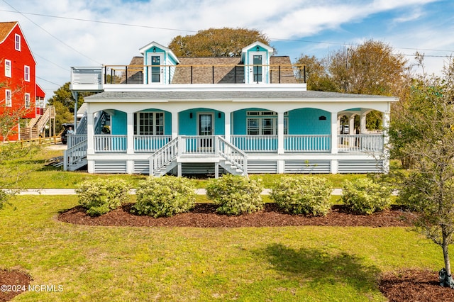 view of front of house with covered porch and a front yard