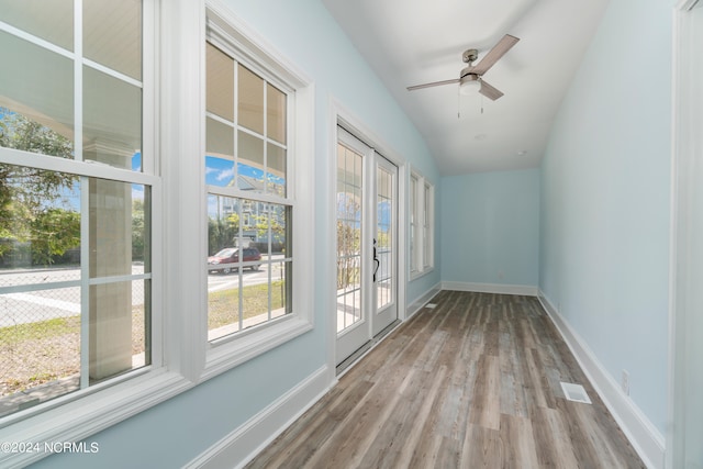 unfurnished sunroom featuring lofted ceiling and ceiling fan