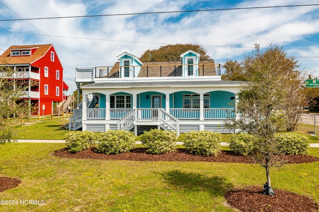 view of front of house featuring a front yard and a porch