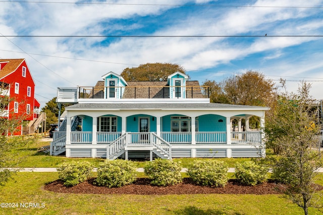 view of front of house with a porch and a front yard