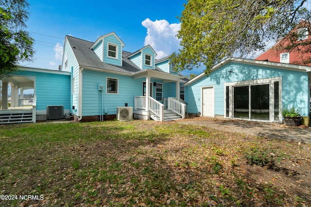 back of property featuring a yard and central air condition unit