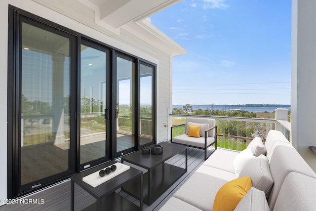 balcony featuring a water view and an outdoor hangout area