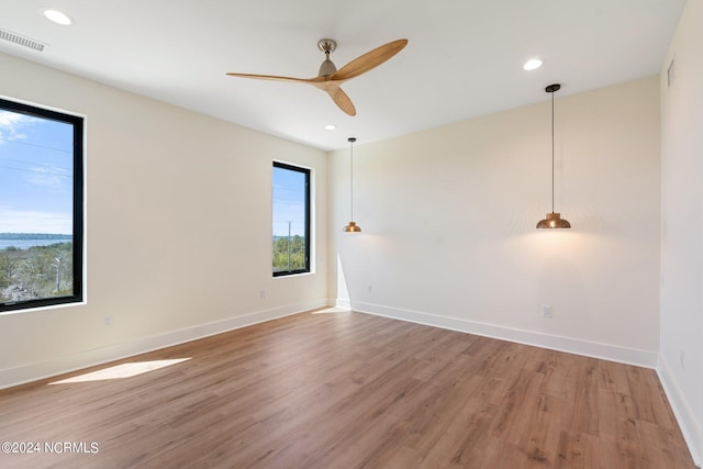 empty room featuring light hardwood / wood-style flooring and ceiling fan