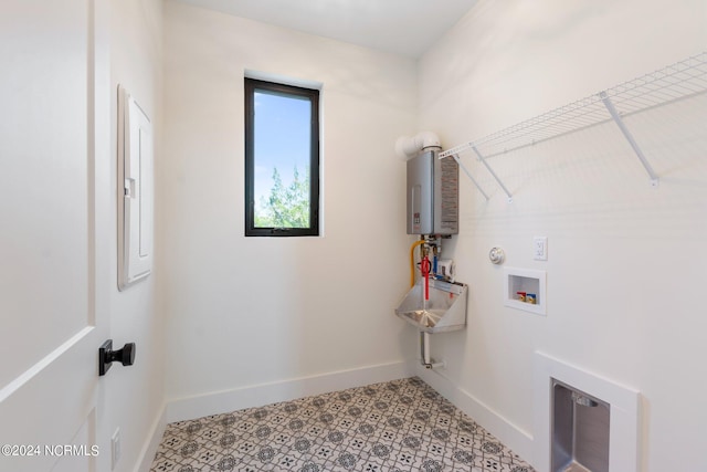 laundry area featuring hookup for a gas dryer, washer hookup, tankless water heater, and light tile floors