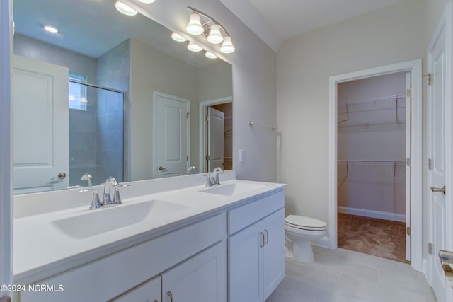 bathroom featuring tile floors, toilet, double sink, and oversized vanity