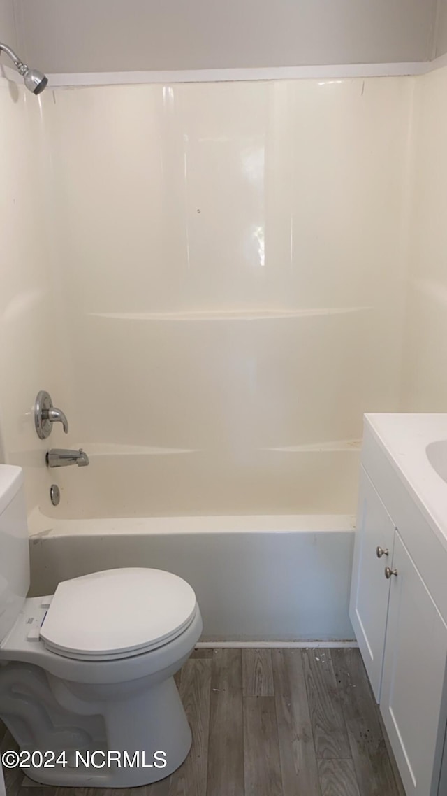 full bathroom with wood-type flooring, vanity, toilet, and shower / tub combination