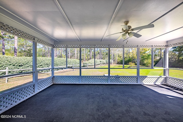 unfurnished sunroom featuring ceiling fan