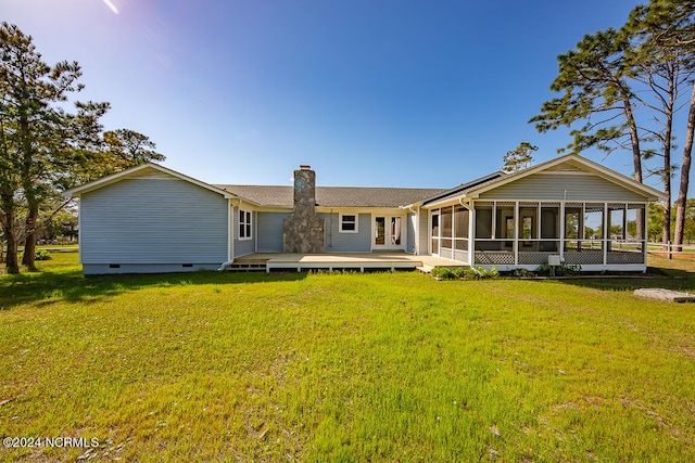 back of house with a lawn and a sunroom