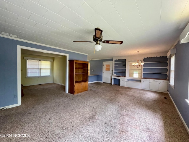 unfurnished living room with ornamental molding, dark carpet, and ceiling fan with notable chandelier