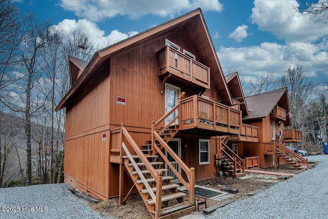 exterior space featuring stairway and a wooden deck