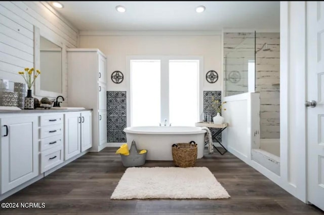 bathroom featuring hardwood / wood-style floors, vanity, and separate shower and tub